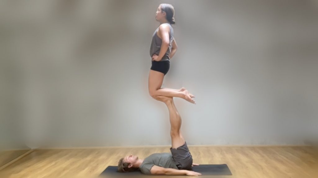 Marie kneeling on Tomas's foot, a posture called shin to foot