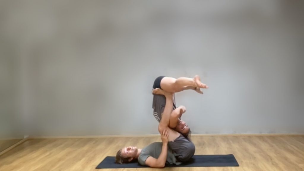 Marie in folded leaf whip position on Tomas' legs